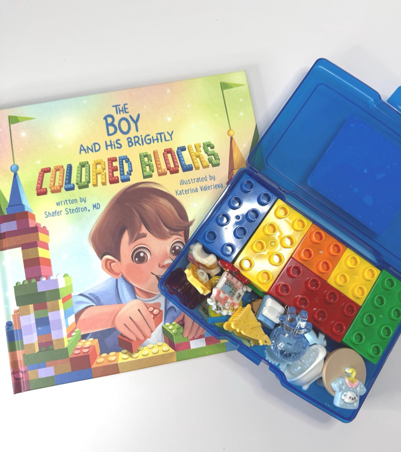 Colorful building blocks in a tin with a children's book titled 'The Boy and His Brightly Colored Blocks'.