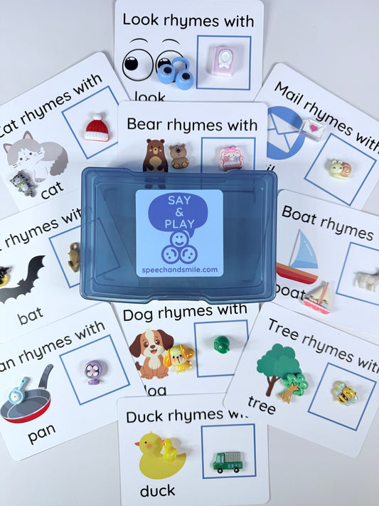 Educational cards with rhyming words and a blue toy on a white background