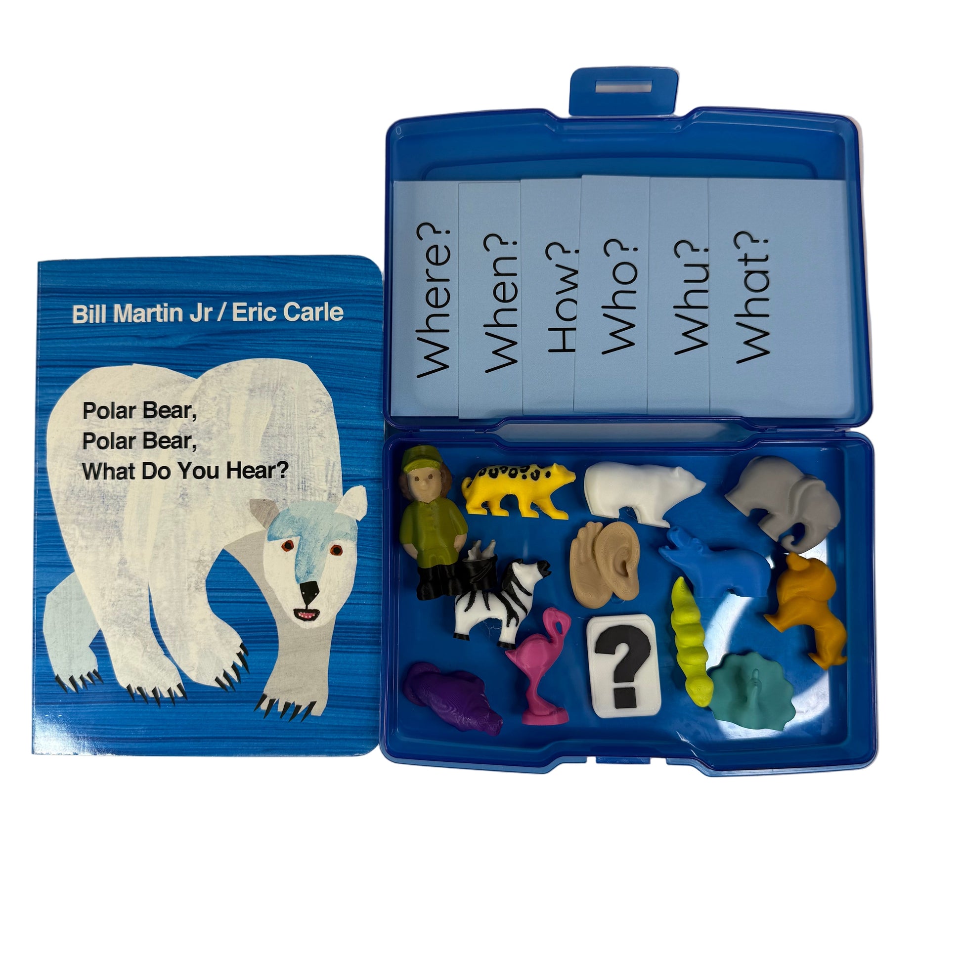 Open children's book with animal figures and question cards on a white background